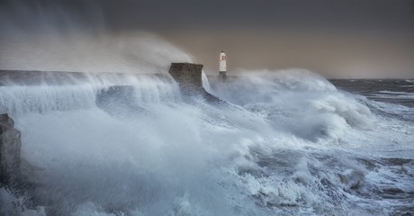 Fototapeta na wymiar Hurricane Brian The forces of nature engulf the pier and lighthouse as Storm Brian lands on the Porthcawl coast of South Wales, UK.