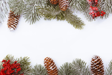 Christmas frame border on white, branches, cones and red berries