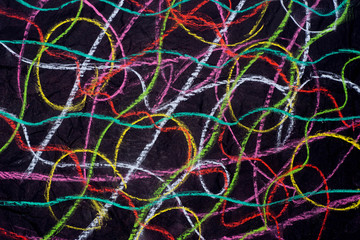 multicolored crayon doodles on black paper