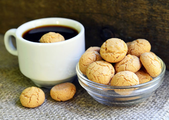 Amaretti cookies.Typical Italian almond amarettini biscuits and cup of coffee.Selective focus.