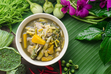 Bamboo shoot soup with pumpkin and mushrooms on wooden table. Thai food concept.