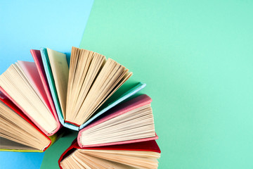 Top view of bright colorful hardback books in a circle.