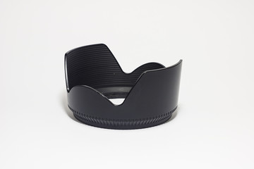 Black plastic camera lens hood isolated on a white background