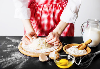 Making dough by female hands at bakery