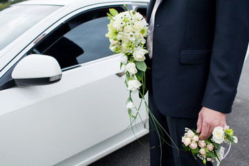 Groom holding a wedding bouquet