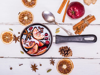 mulled wine with spices and fruits in an aluminum container