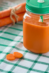 Carrot juice in glass and fresh carrots. Healthy food.