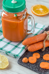 Carrot juice in glass and fresh carrots. Healthy food.