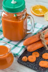 Carrot juice in glass and fresh carrots. Healthy food.