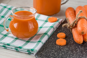 Carrot juice in glass and fresh carrots. Healthy food.