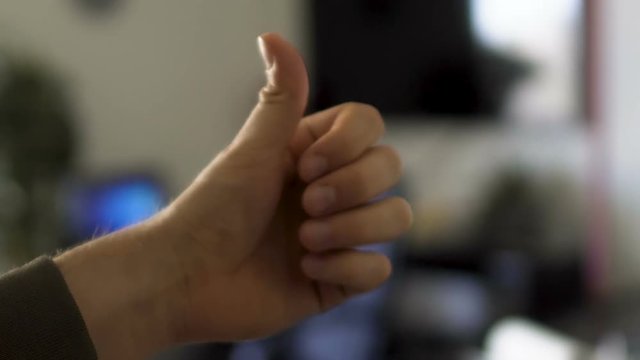 Man's hand flipping a coin, fortune and risk, decision of great moment, chance