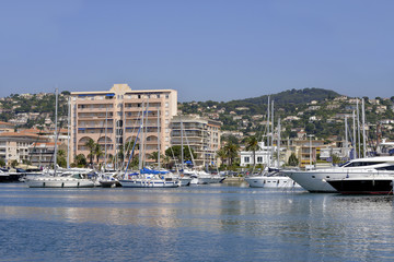 Fototapeta na wymiar Harbor and town of Golfe-Juan, commune of the Alpes-Maritimes department, which belongs in turn to the Provence-Alpes-Côte d'Azur region of France