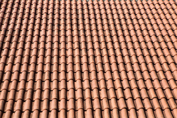orange tile made of clay lying on the roof
