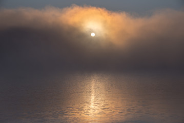 Fog over Mary Lake at sunrise in Port Sydney, Ontario, Canada.