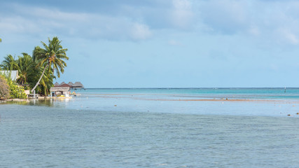 french Polynesia, panorama of the lagoon with on piles huts of a resort

