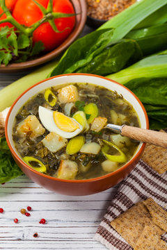 Green Russian Potato, Spinach, and Sorrel Soup with egg. Selective focus.