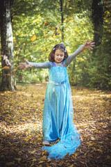 Little girl playing with leaves in the wood,selective focus