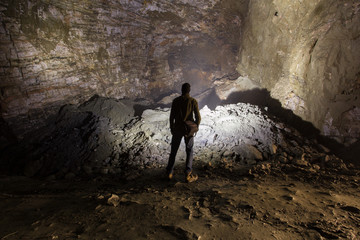 Miner in the underground quartz ore mine shaft tunnel