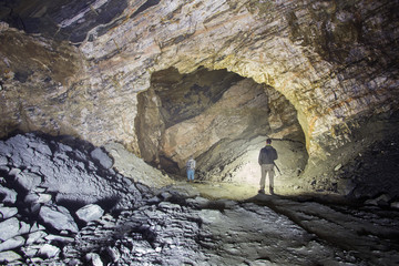 Miner in the underground quartz ore mine shaft tunnel