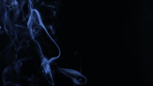 Blue smoke in the form of rings on a black background.