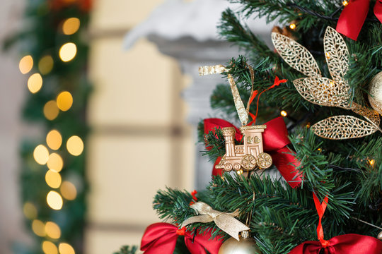 Christmas Toy Train And Garland On The Fir Tree