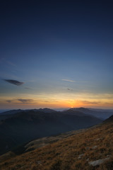 Fototapeta premium Sunset on the hills. The moon will rise shortly.