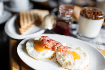 Breakfast - toasts, eggs, bacon. English Breakfast in the morning in a cafe. small depth of sharpness