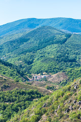 Fototapeta na wymiar Ardeche landscape, panorama of mountains in France, in summer, with a village in a small valley 