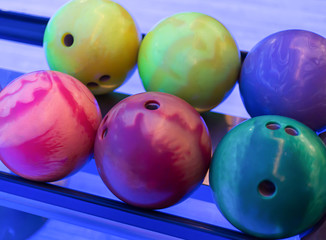 Fototapeta na wymiar colored bowling ball yellow pink lie in a line close up