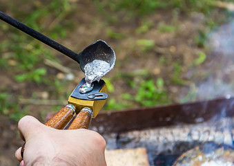 Traditional manual metal casting process to form aluminum tin press bullets old musket