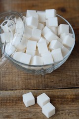 White refined sugar cubes in a glass bowl 