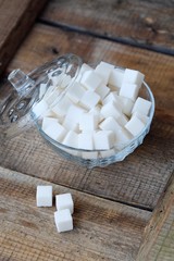 White refined sugar cubes in a glass bowl 