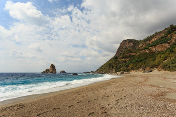 Paradise beach with mountain by the sea and rock islands in the 