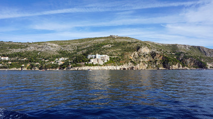 wild coast of croatian town dubrovnik from a boat