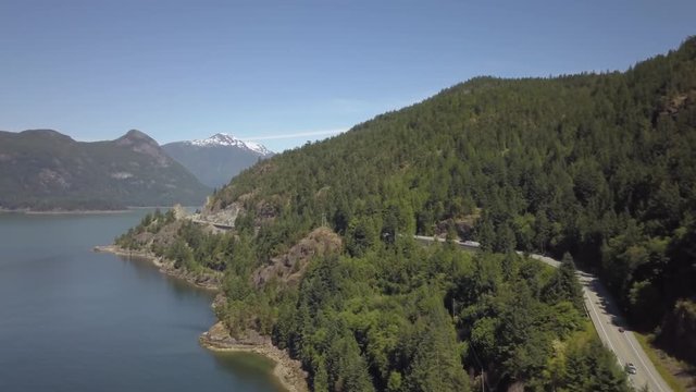 Aerial 4k drone view of Sea to Sky Highway in Howe Sound during a bright and sunny summer day. Taken North of Vancouver, British Columbia, Canada.