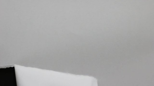 Tearing paper into hole black screen background - Powered by Adobe