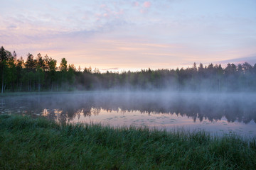 Obraz na płótnie Canvas Foggy morning at forest pond landscape Finland
