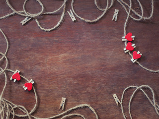 Mini love heart wooden clothespins with natural rope on wooden background and copy space, Concept...