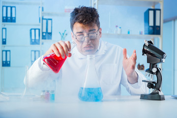 Funny mad chemist working in a laboratory