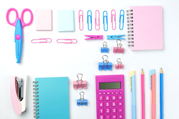 Stationary concept, Flat Lay top view Photo of school supplies scissors, pencils, paper clips,calculator,sticky note,stapler and notepad in pastel tone on white background with copy space, flat lay 