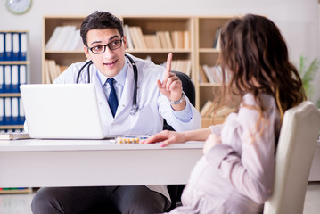 Fototapeta premium Pregnant woman visiting doctor for consultation