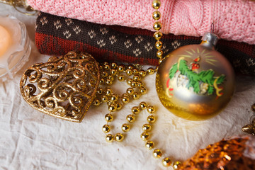 Christmas toys and a stack of knitted sweaters
