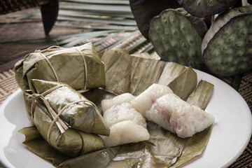 Fototapeta na wymiar Bananas with Sticky Rice (Khao Tom Mat) A popular Thai snack sticky rice wrapped in banana leaf mixed with taro, black bean, mung bean or peanut