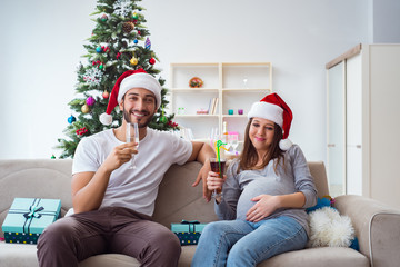 Young family expecting child baby celebrating christmas