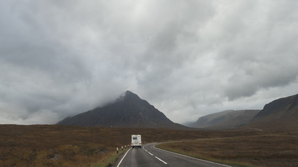 RV pick-up trailer on mountain road in Scotland