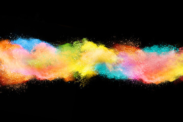 Explosion of colored powder on black background