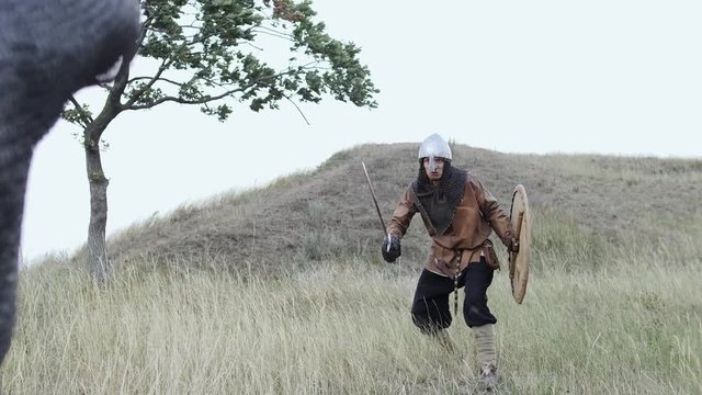 A Viking warrior throws a spear during an attack.