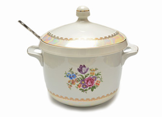 Ceramic saucepan with ladle on white background