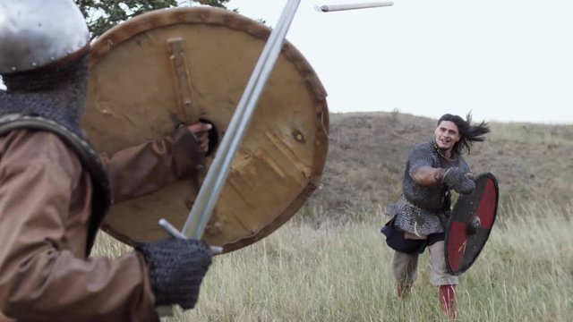 A Viking warrior throws a spear during an attack.