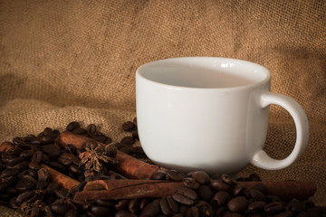 Coffee beans and cup coffee on the cloth sack select focus, Vintage color tone or dark tone